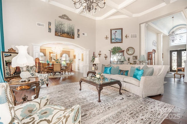 3441 Club Ridge Ct, Gastonia, NC 28056 - living room featuring a chandelier, a towering ceiling, arched walkways, coffered ceiling, and decorative columns