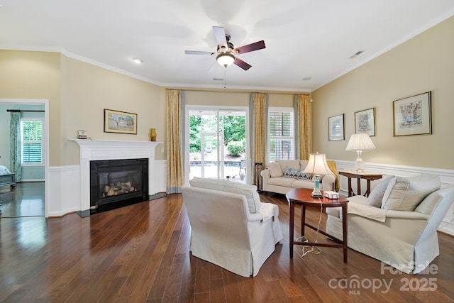 964 Knob Creek Ln, Fort Mill, SC 29708 - living area with ceiling fan, dark wood-type flooring, wainscoting, ornamental molding, and a glass covered fireplace