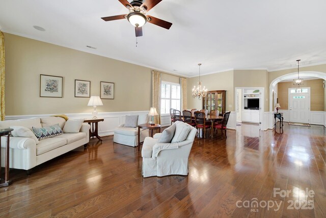 964 Knob Creek Ln, Fort Mill, SC 29708 - living area featuring arched walkways, ceiling fan, dark wood finished floors, a wainscoted wall, and a chandelier