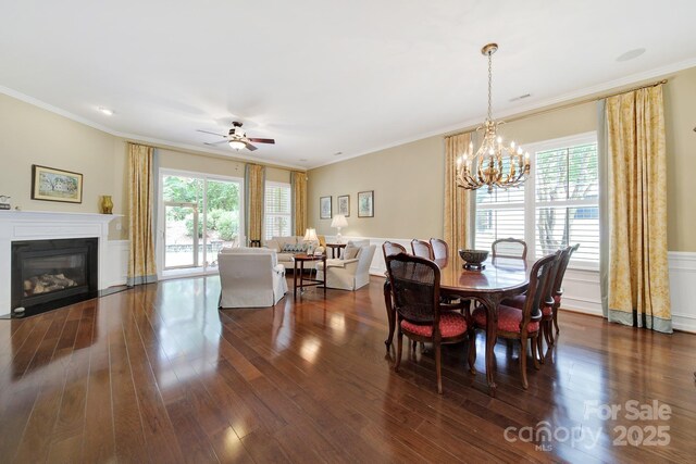 964 Knob Creek Ln, Fort Mill, SC 29708 - dining area featuring a chandelier, healthy amount of natural light, dark wood-type flooring, ornamental molding, and a wainscoted wall