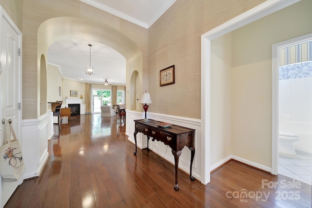 964 Knob Creek Ln, Fort Mill, SC 29708 - hall with arched walkways, dark wood-type flooring, crown molding, wainscoting, and wallpapered walls