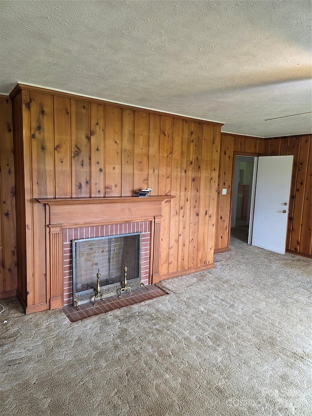 4298 NC-41 Hwy S, Fairmont, NC 28340 - unfurnished living room with a fireplace, carpet, a textured ceiling, wood walls, and baseboards