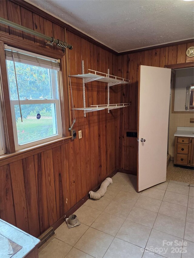 4298 NC-41 Hwy S, Fairmont, NC 28340 - laundry area with wood walls, a textured ceiling, and light tile patterned flooring