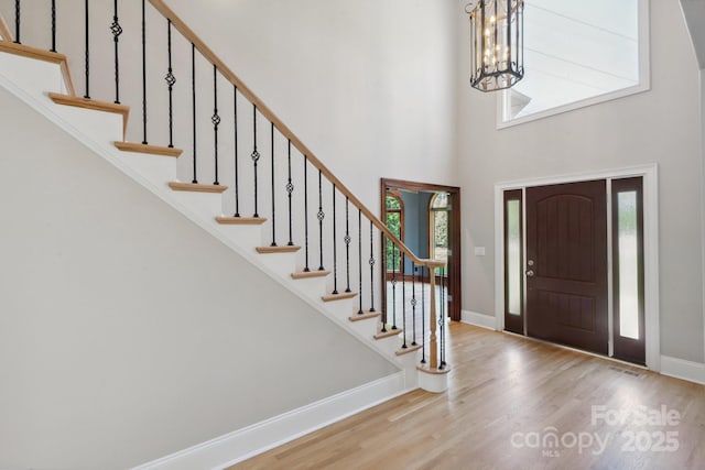 122 Long Cove Ln, Mooresville, NC 28117 - foyer entrance featuring a chandelier, wood finished floors, baseboards, a high ceiling, and stairs