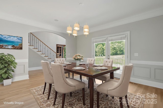 122 Long Cove Ln, Mooresville, NC 28117 - dining space featuring ornamental molding, light wood-style floors, a wainscoted wall, arched walkways, and stairway