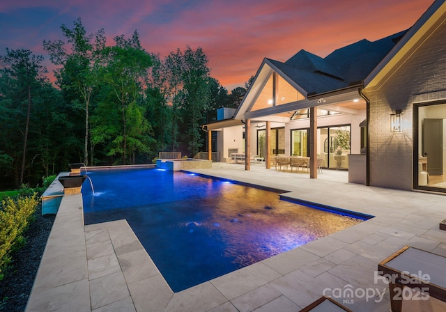 15037 June Washam Rd, Davidson, NC 28036 - pool at dusk featuring a patio and an outdoor pool