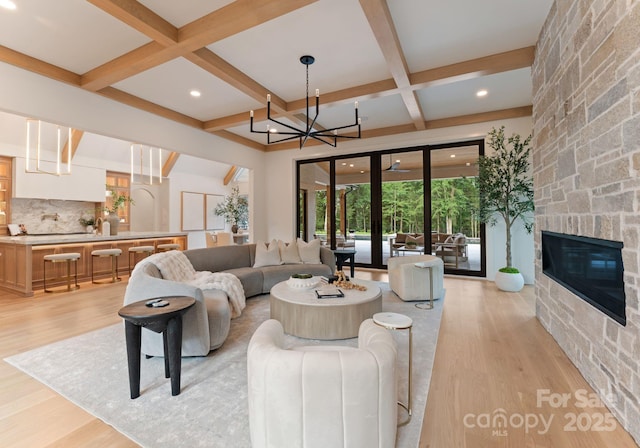 15037 June Washam Rd, Davidson, NC 28036 - living room featuring coffered ceiling, light wood-type flooring, beamed ceiling, a stone fireplace, and recessed lighting