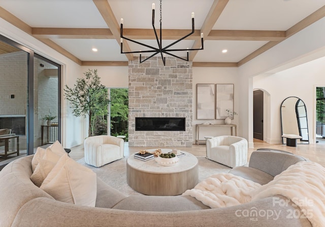 15037 June Washam Rd, Davidson, NC 28036 - living room featuring a fireplace, coffered ceiling, beam ceiling, a chandelier, and arched walkways