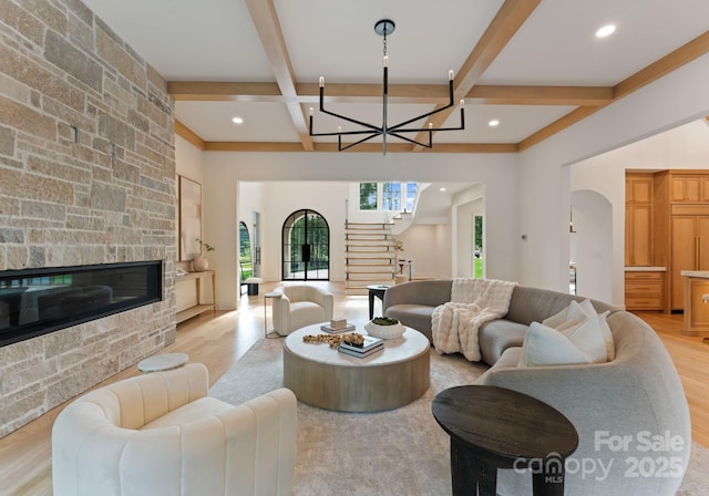 15037 June Washam Rd, Davidson, NC 28036 - living area featuring arched walkways, stairway, a chandelier, coffered ceiling, and beamed ceiling