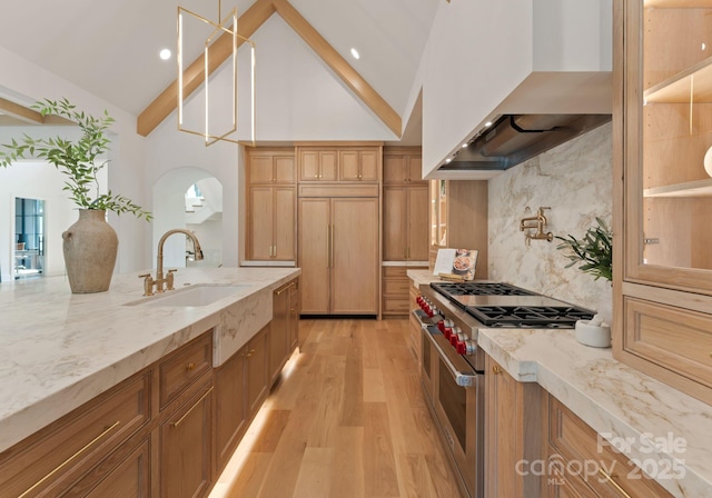 15037 June Washam Rd, Davidson, NC 28036 - kitchen featuring double oven range, wall chimney exhaust hood, light wood-type flooring, light stone countertops, and backsplash