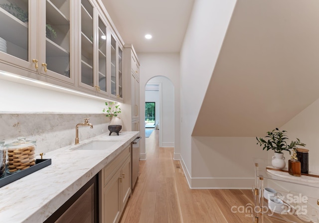 15037 June Washam Rd, Davidson, NC 28036 - bar area featuring arched walkways, light wood-type flooring, recessed lighting, tasteful backsplash, and stainless steel dishwasher