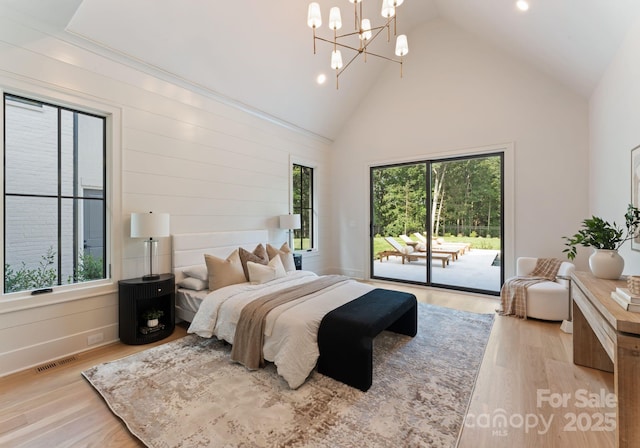 15037 June Washam Rd, Davidson, NC 28036 - bedroom with high vaulted ceiling, access to exterior, light wood finished floors, a chandelier, and recessed lighting