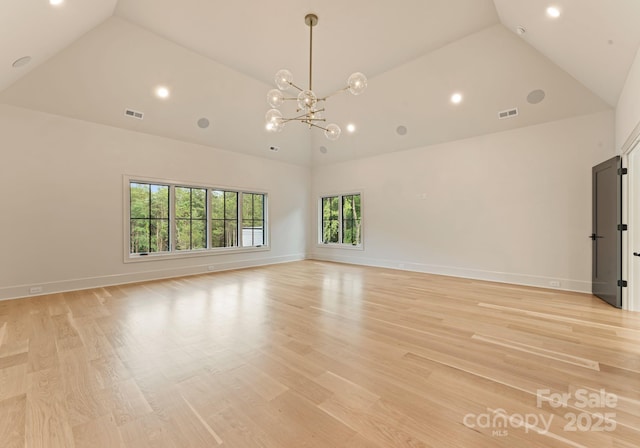 15037 June Washam Rd, Davidson, NC 28036 - empty room with high vaulted ceiling, recessed lighting, a chandelier, and light wood-style flooring