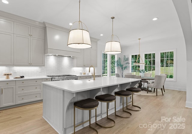 2921 Windsor Ave, Charlotte, NC 28209 - kitchen with premium range hood, decorative backsplash, light countertops, healthy amount of natural light, and recessed lighting