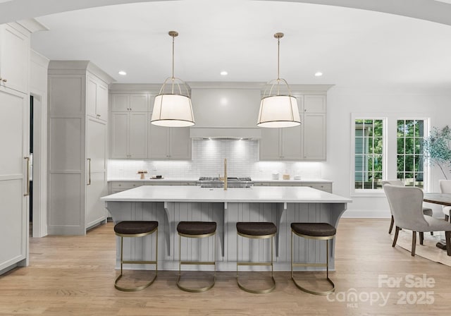 2921 Windsor Ave, Charlotte, NC 28209 - kitchen featuring light wood finished floors, light countertops, decorative backsplash, and recessed lighting