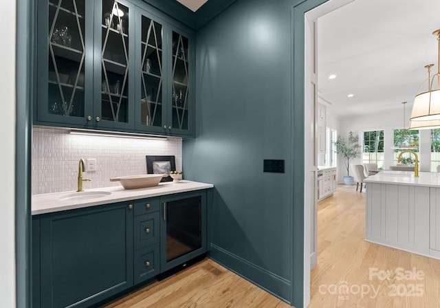 2921 Windsor Ave, Charlotte, NC 28209 - bar area with light wood-type flooring, decorative backsplash, hanging light fixtures, and recessed lighting