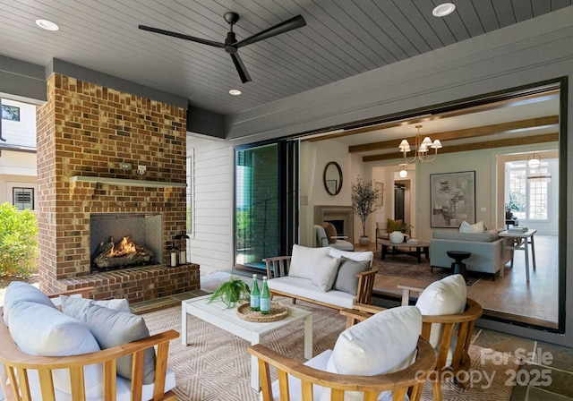 2921 Windsor Ave, Charlotte, NC 28209 - living room with an outdoor brick fireplace, ceiling fan, a chandelier, and recessed lighting