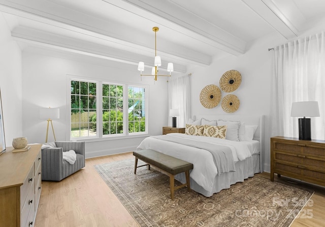 2921 Windsor Ave, Charlotte, NC 28209 - bedroom with beamed ceiling, light wood-style flooring, and a chandelier