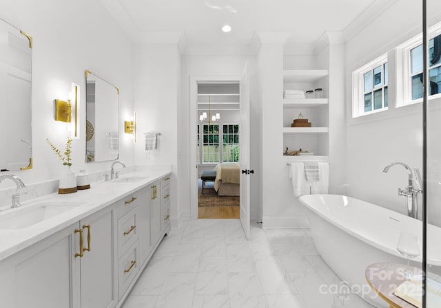 2921 Windsor Ave, Charlotte, NC 28209 - bathroom featuring a freestanding tub, double vanity, marble finish floors, ensuite bathroom, and ornamental molding