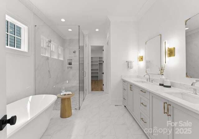 2921 Windsor Ave, Charlotte, NC 28209 - full bathroom with a shower stall, double vanity, a freestanding tub, marble look tiles, and recessed lighting