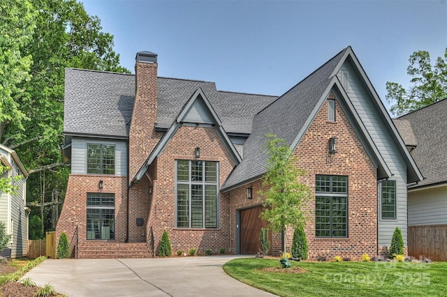 2921 Windsor Ave, Charlotte, NC 28209 - tudor house featuring brick siding, driveway, a chimney, a garage, and a shingled roof