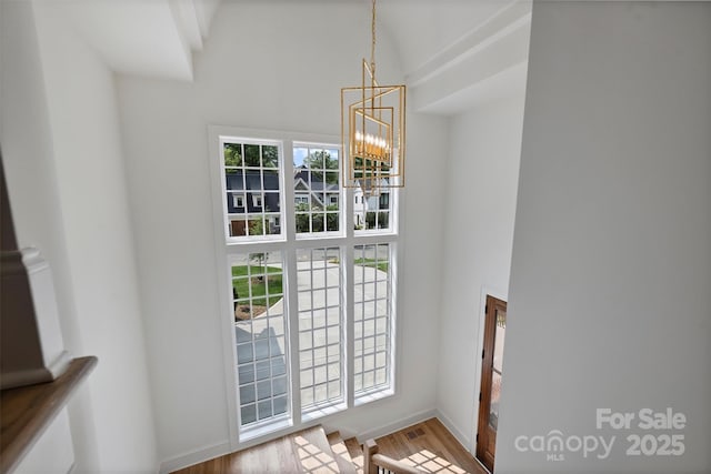 2921 Windsor Ave, Charlotte, NC 28209 - entrance foyer featuring a chandelier, a towering ceiling, and wood finished floors