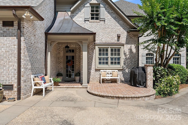 2954 Reynolds Sq, Winston Salem, NC 27106 - doorway to property with brick siding, a standing seam roof, metal roof, and a patio