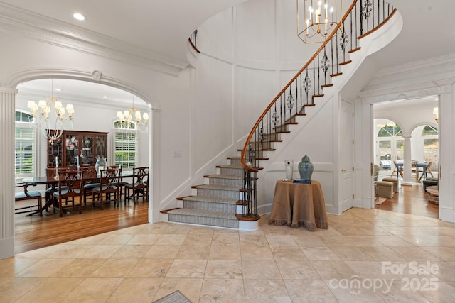 2954 Reynolds Sq, Winston Salem, NC 27106 - stairway with a chandelier, a decorative wall, ornamental molding, and ornate columns