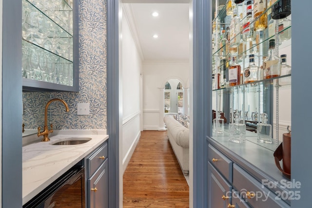 2954 Reynolds Sq, Winston Salem, NC 27106 - indoor wet bar with crown molding, wine cooler, and light wood-style flooring