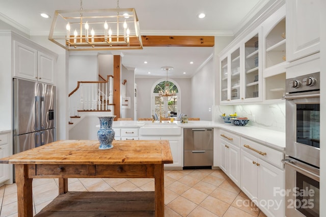 2954 Reynolds Sq, Winston Salem, NC 27106 - kitchen featuring a chandelier, a sink, stainless steel appliances, light tile patterned floors, and tasteful backsplash