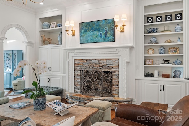 2954 Reynolds Sq, Winston Salem, NC 27106 - living area with built in shelves, crown molding, decorative columns, and a stone fireplace