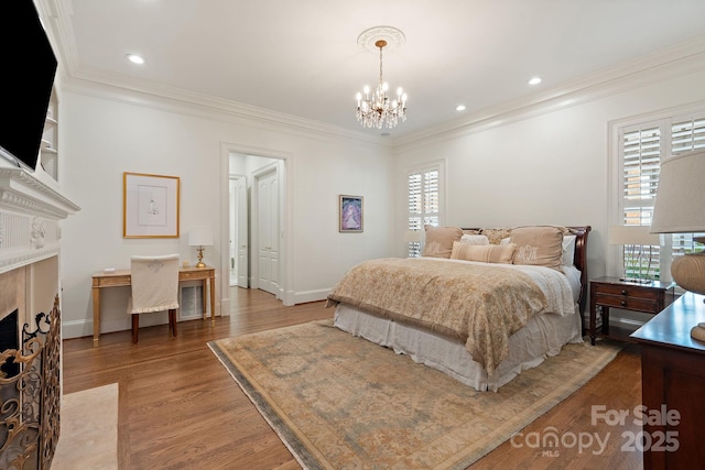 2954 Reynolds Sq, Winston Salem, NC 27106 - bedroom with a premium fireplace, a chandelier, crown molding, wood finished floors, and recessed lighting