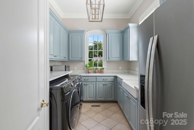 2954 Reynolds Sq, Winston Salem, NC 27106 - washroom featuring separate washer and dryer, cabinet space, crown molding, and light tile patterned floors