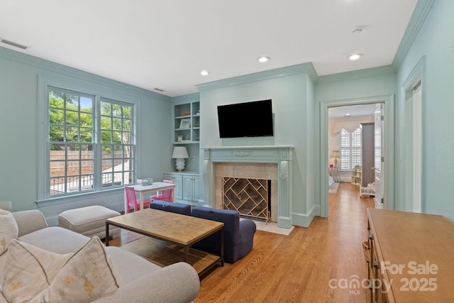 2954 Reynolds Sq, Winston Salem, NC 27106 - living room with plenty of natural light, ornamental molding, light wood-style floors, a premium fireplace, and recessed lighting