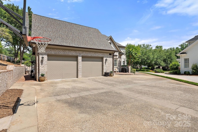 2954 Reynolds Sq, Winston Salem, NC 27106 - view of property exterior featuring a shingled roof, driveway, brick siding, and a garage