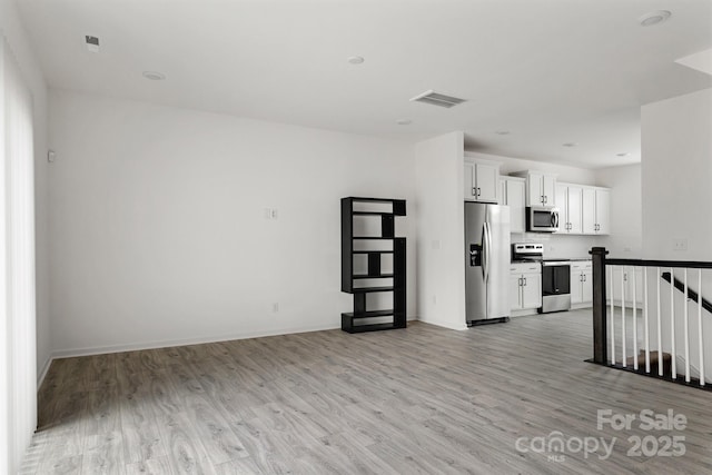 15034 Scoter St, Charlotte, NC 28262 - unfurnished living room featuring light wood-style flooring and baseboards