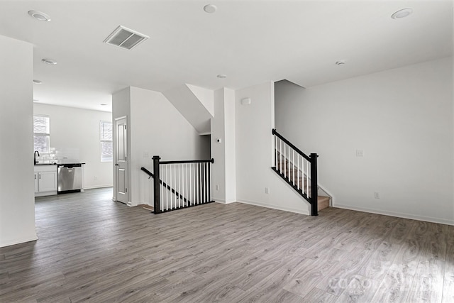 15034 Scoter St, Charlotte, NC 28262 - empty room with wood finished floors, a sink, and baseboards