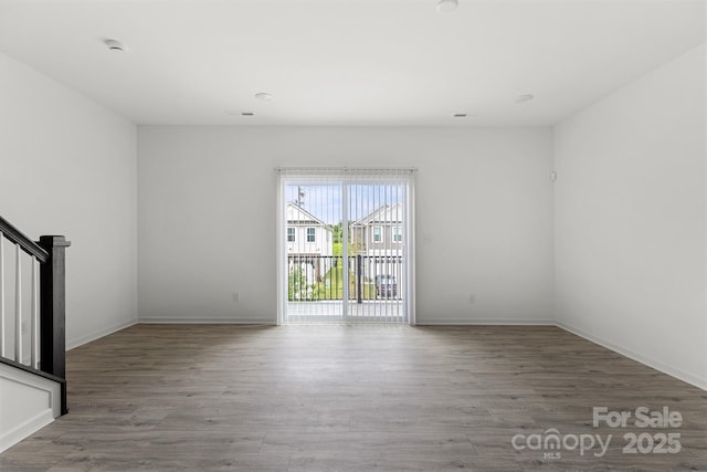 15034 Scoter St, Charlotte, NC 28262 - unfurnished room with wood finished floors, baseboards, stairs, and a smoke detector