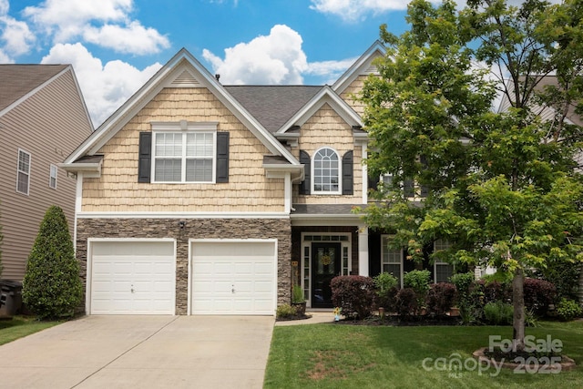 3351 Streamside Dr, Davidson, NC 28036 - craftsman-style home with concrete driveway, stone siding, a front yard, and an attached garage