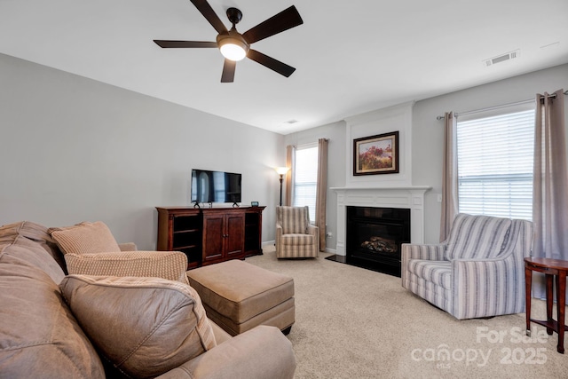 3351 Streamside Dr, Davidson, NC 28036 - living area with ceiling fan, light colored carpet, and a fireplace with flush hearth
