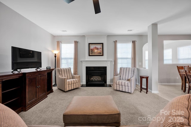 3351 Streamside Dr, Davidson, NC 28036 - living area with light carpet, a ceiling fan, plenty of natural light, and a fireplace with flush hearth
