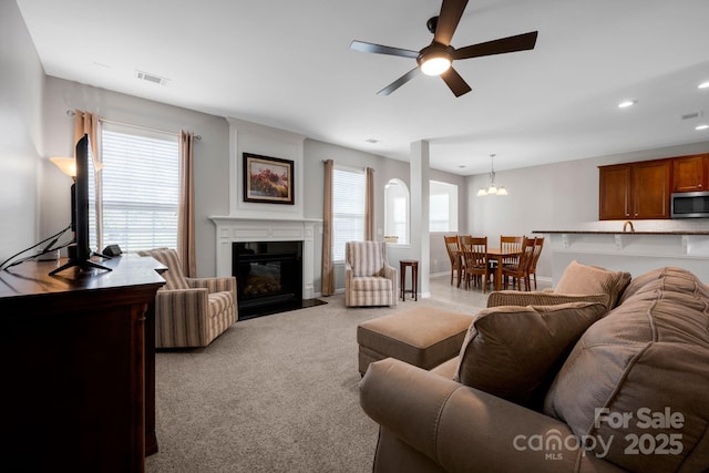 3351 Streamside Dr, Davidson, NC 28036 - living room with a ceiling fan, light carpet, a fireplace with flush hearth, a chandelier, and recessed lighting