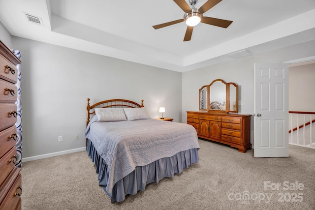 3351 Streamside Dr, Davidson, NC 28036 - carpeted bedroom with a tray ceiling and a ceiling fan