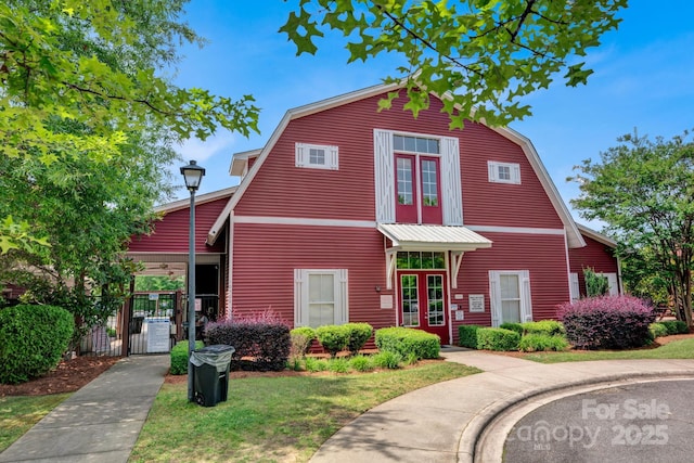 3351 Streamside Dr, Davidson, NC 28036 - dutch colonial featuring a gambrel roof and a gate