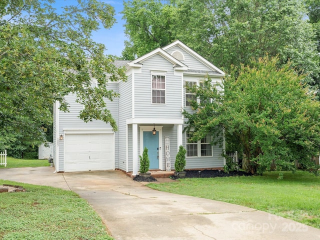 1003 Snake River Ct, Monroe, NC 28110 - traditional-style home with concrete driveway, a front lawn, and an attached garage