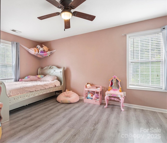 1003 Snake River Ct, Monroe, NC 28110 - bedroom featuring wood finished floors, multiple windows, and ceiling fan