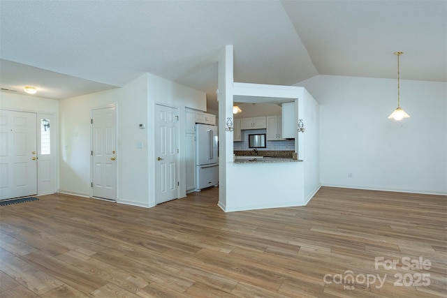 16 Red Barn Ln, Fletcher, NC 28732 - unfurnished living room featuring light wood-style flooring and lofted ceiling