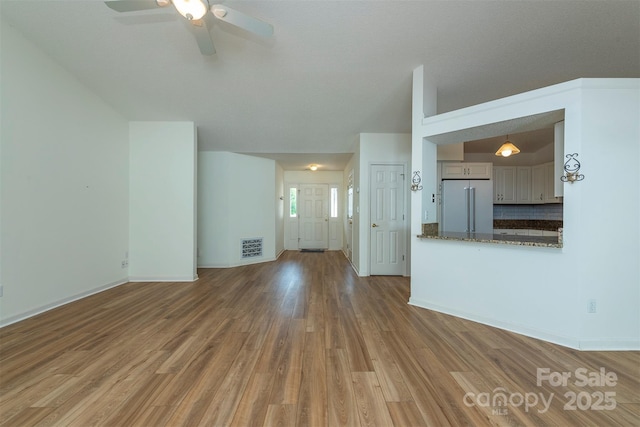 16 Red Barn Ln, Fletcher, NC 28732 - unfurnished living room featuring wood finished floors and ceiling fan