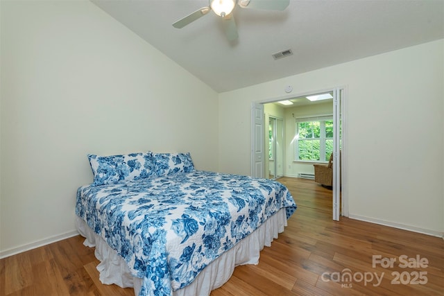 16 Red Barn Ln, Fletcher, NC 28732 - bedroom with wood finished floors, vaulted ceiling, baseboard heating, and a ceiling fan