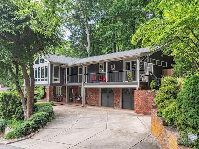 95 Harmon Ave, Lake Junaluska, NC 28745 - multi unit property with an attached garage, a balcony, concrete driveway, brick siding, and a sunroom